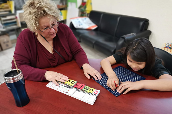 Professor Alma teaching blind students